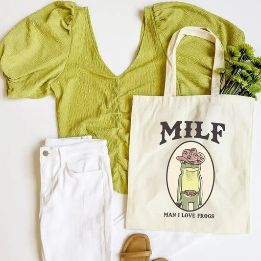 Beige tote bag with an image of a cartoon frog in a pink cowboy hat and the words "MILF: Man I Love Frogs"