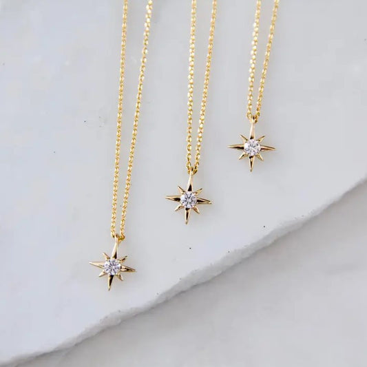 Product photography of three gold necklaces