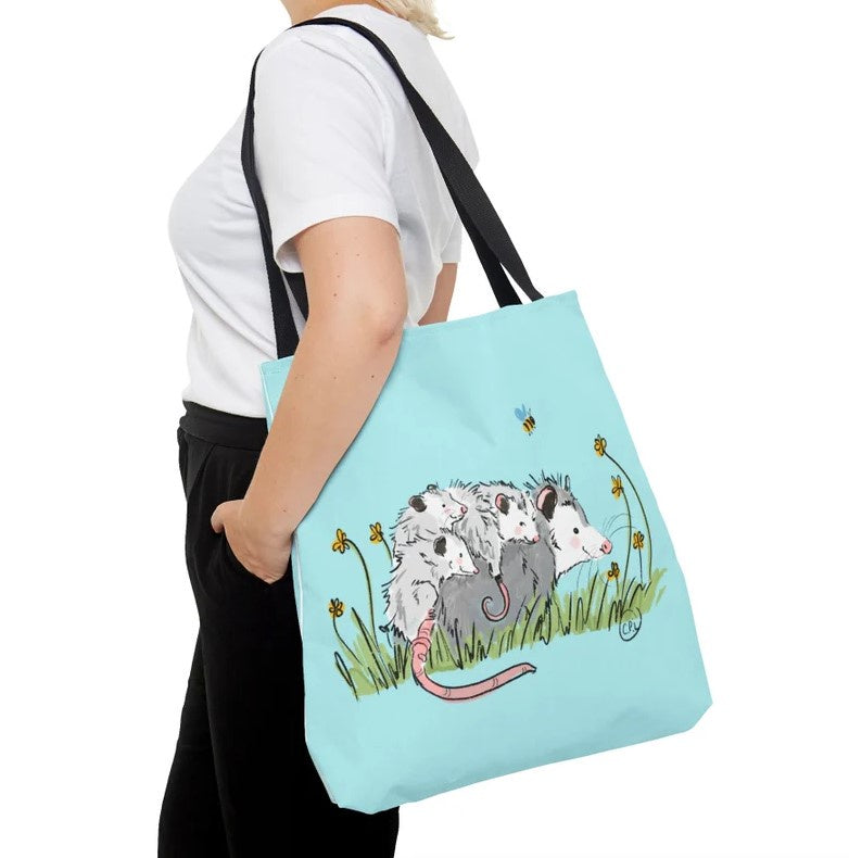 blue tote bag with a mom possum and her four babies on her back