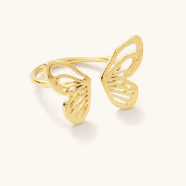 An adjustable gold ring shaped like a monarch butterfly with the closure in between the two wings.