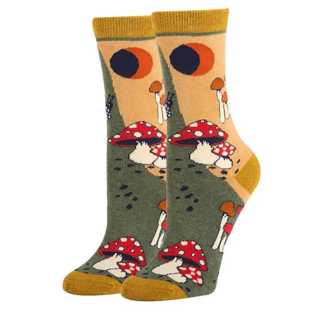 Women's calf socks patterned with cartoony red and white mushrooms and snails over a mellow green and yellow background.