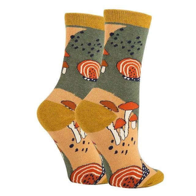 Women's calf socks patterned with cartoony red and white mushrooms and snails over a mellow green and yellow background.