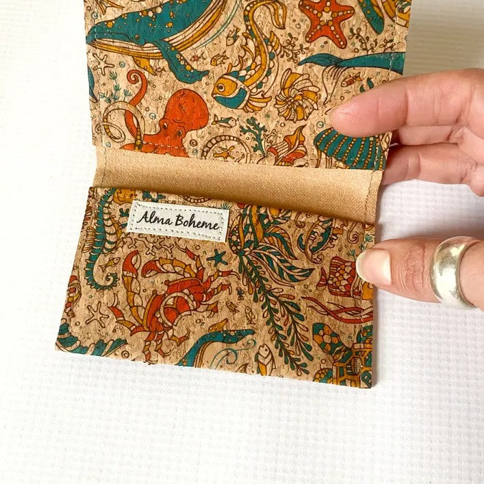 Cork wallet with sea creatures patterned on it in blue, yellow and orange
