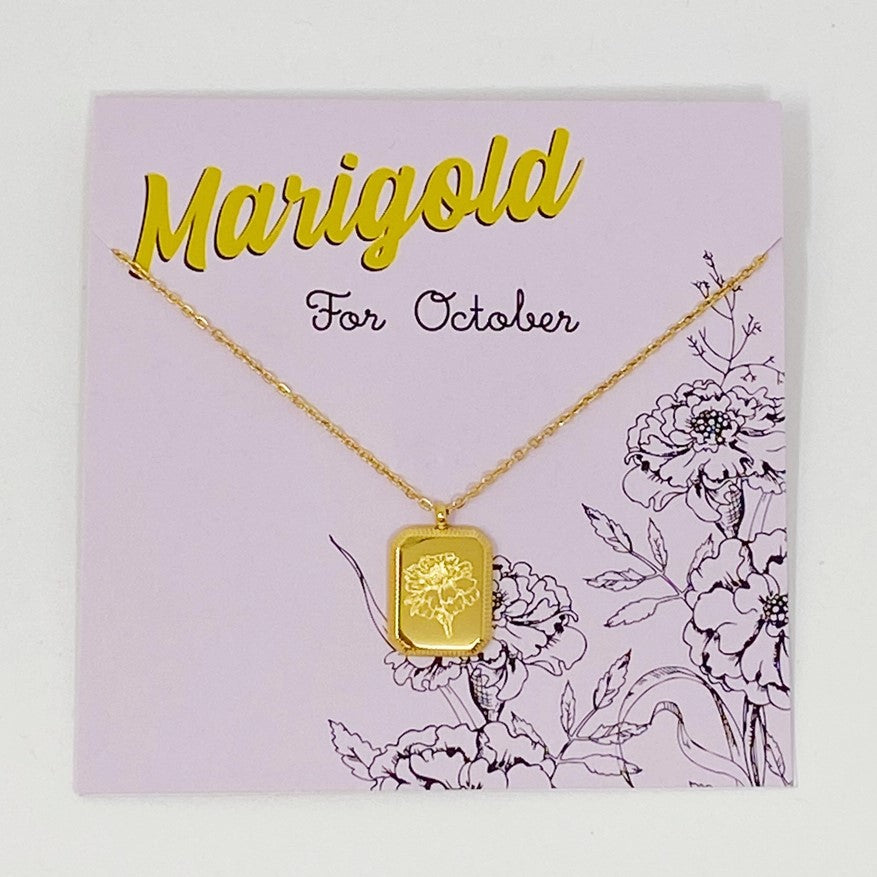 gold plated necklace with a pendant engraved with marigolds for October birthdays