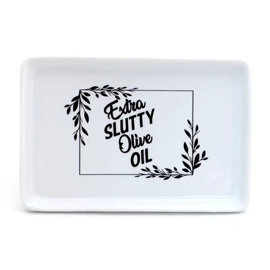 White ceramic tray with leave design and text "Extra slutty olive oil"