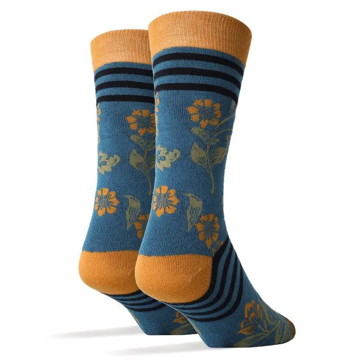 Blue calf socks with a delicate yellow flower print and black bands around the foot and top of the sock.