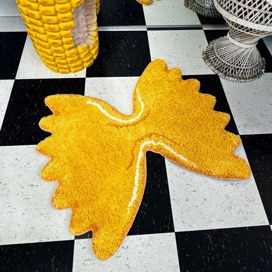 A bright yellow shag rug shaped like a bowtie pasta