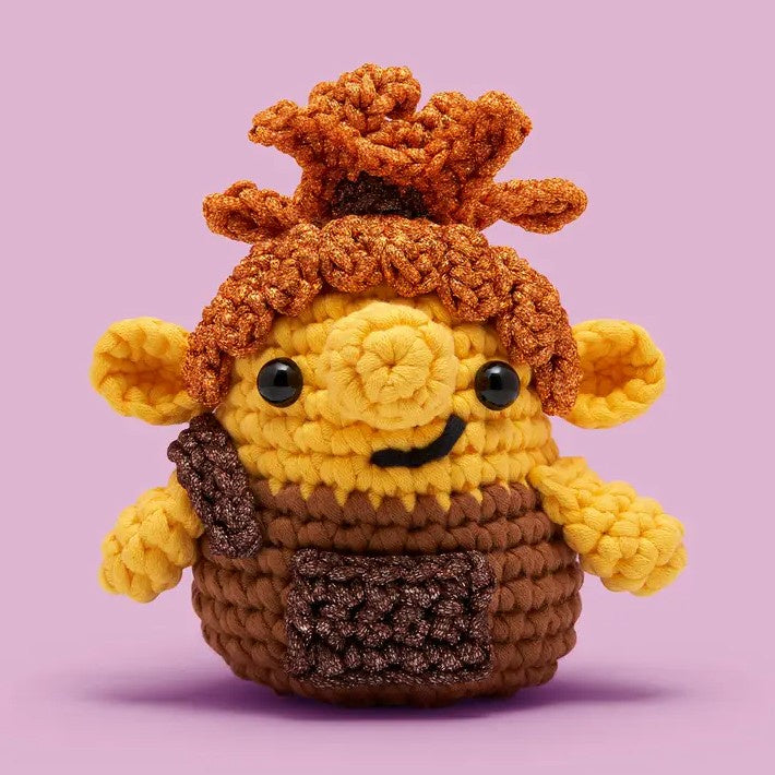 Crocheted brown and yellow troll character