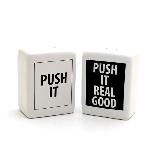 Black and white ceramic salt and peppers shakers that read "push it" and "push it real good"