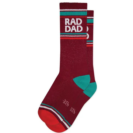 Dark red socks with teal and orange stripes and the words "rad dad" in white at the top