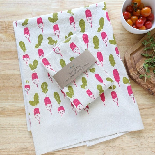 White kitchen towel with pink and green radish pattern