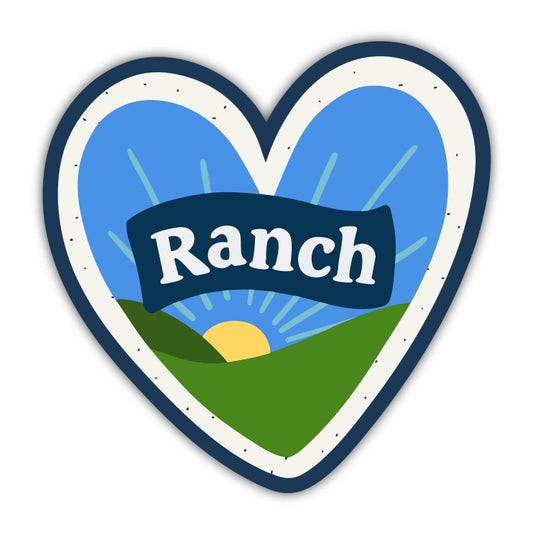 Heart shaped sticker with text that reads "Ranch" in front of a sunny field