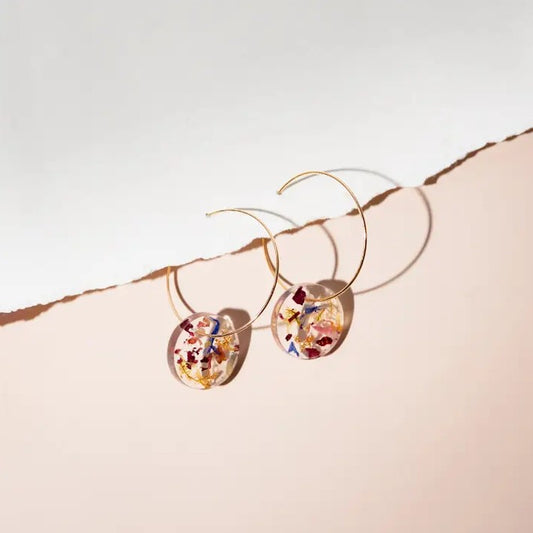 Gold hoop earrings with resin charms filled with flower petals