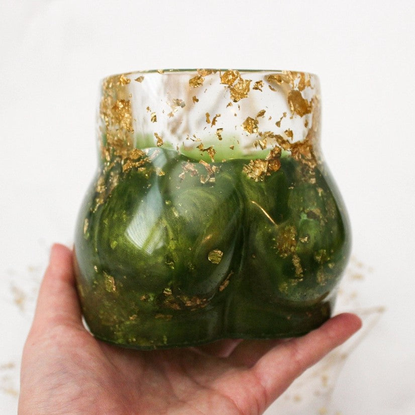 Hand holding resin planter with gold flakes