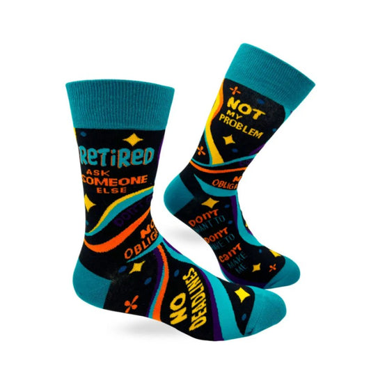Black calf socks with colorful blue, orange and yellow swirls and the words "Retired, ask someone else" on them"