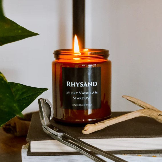 Nine ounce soy wax candle titled "Rhysand" with the scent "musky vanilla and stardust."