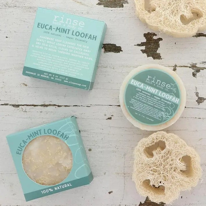 A circular bar of soap containing a natural loofah for exfoliation in the scent Euca-mint.