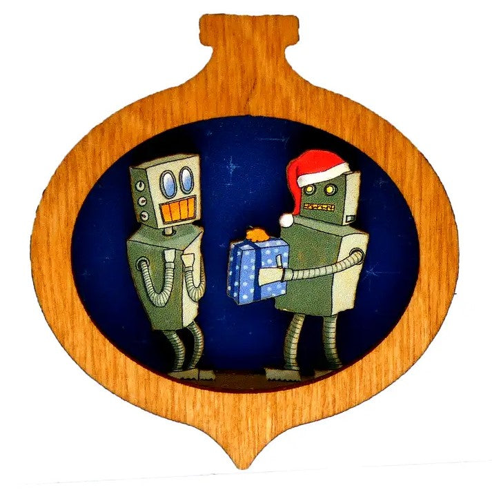 Small wooden Christmas ornament featuring a robot in a Santa hat offering a wrapped gift to another excited robot