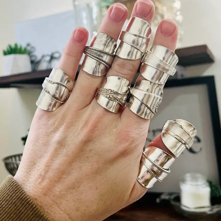 A set of thick silver saddle rings made from spoons.