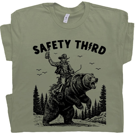 Green t-shirt with an image of a man riding a bear and the words "Safety Third" 
