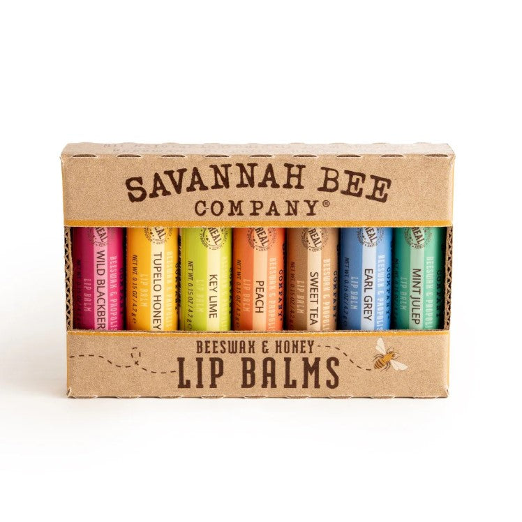 A rainbow assortment of Savannah Bee lip balms in the flavors wild blackberry, tupelo honey, key lime, peach, sweet tea, earl grey and mint julep