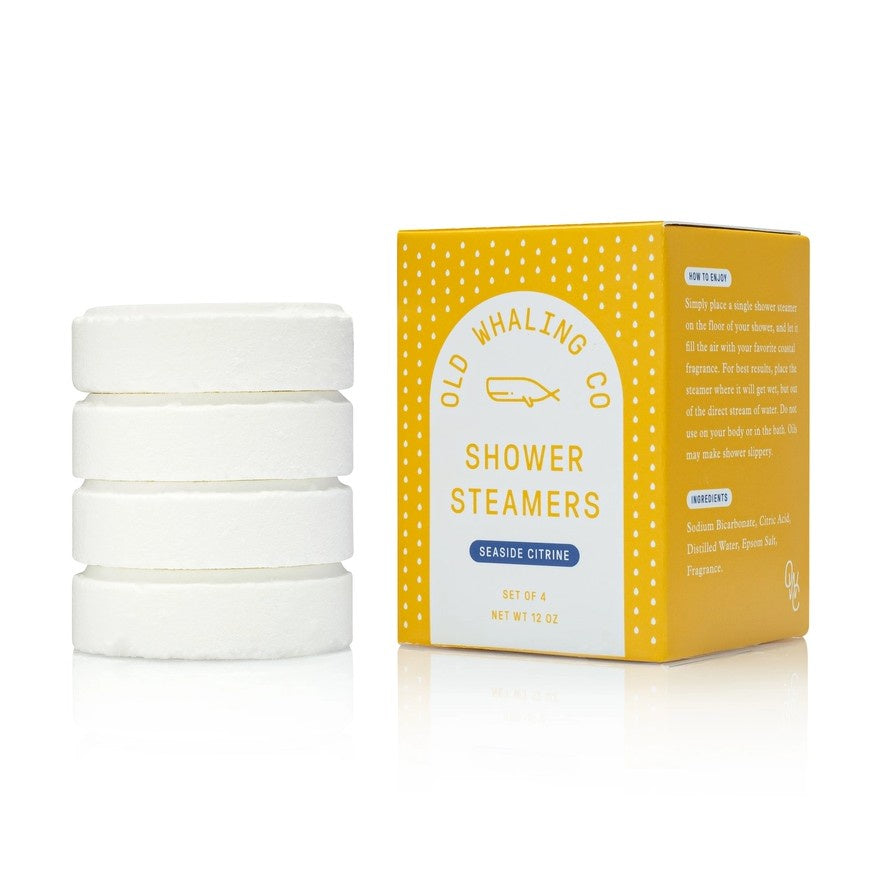 Four white shower steamers packaged in a bright yellow box