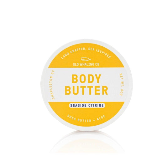 A round tub of seaside citrine scented body butter with white and yellow packaging
