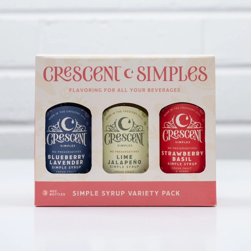 Box of simple syrup bottles in the flavors blueberry lavender, lime jalapeno and strawberry basil