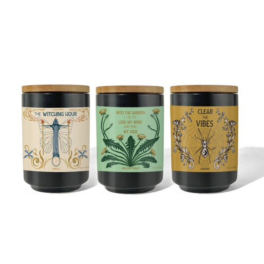 Three candles with decorative labels and wooden lids 