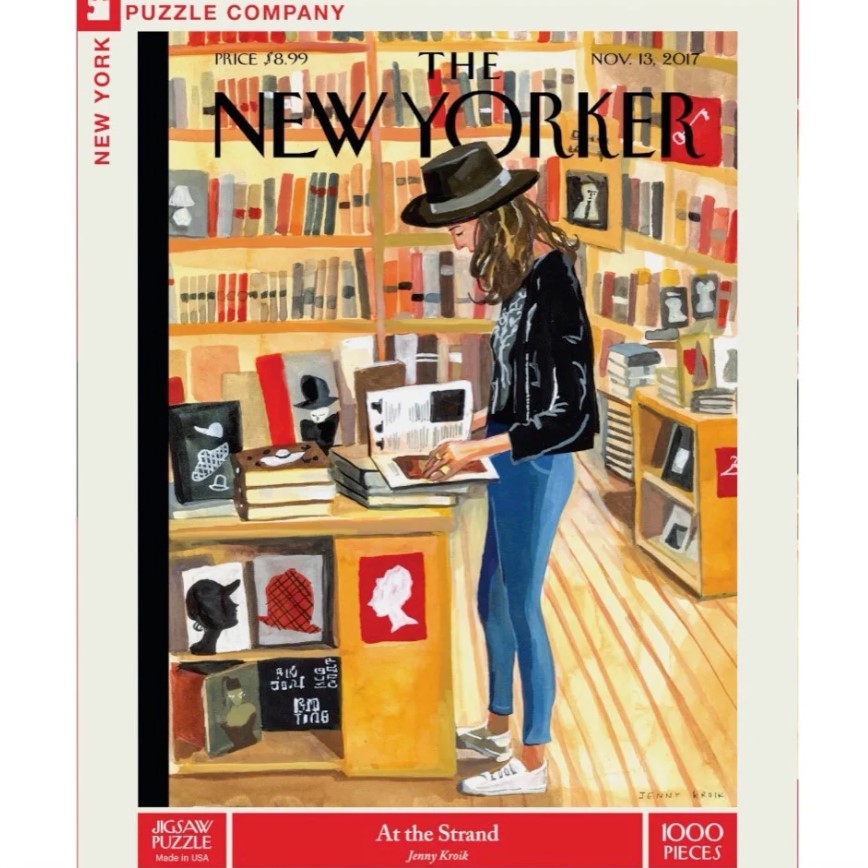 A 1000-piece puzzle depicting a woman in a black fedora hat browsing through books about hats in New York's Strand bookstore.