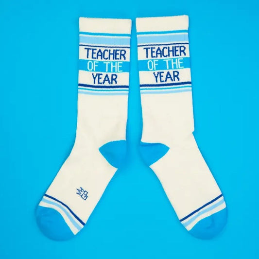 White and blue striped calf socks that read "Teacher of the Year"