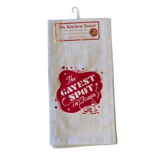 White kitchen towel with an illustration of a sparkling red and white sign reading "The Gayest Spot in Town" and two martini glasses underneath.