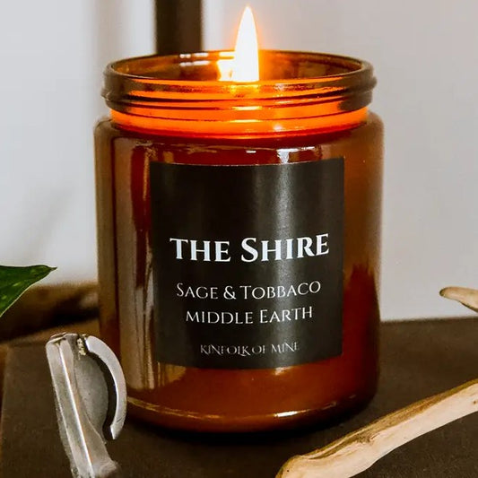 Candle with a black label that reads "The Shire. Sage and Tobacco"