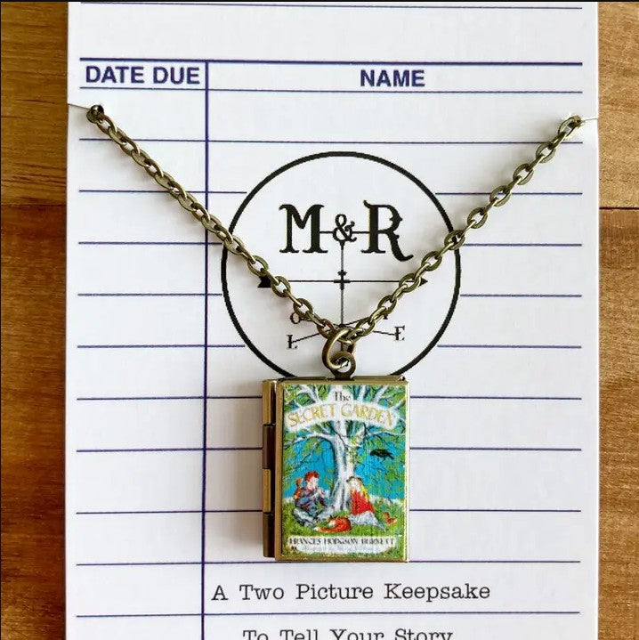 Locket on a silver chain with pendant designed like The Secret Garden book