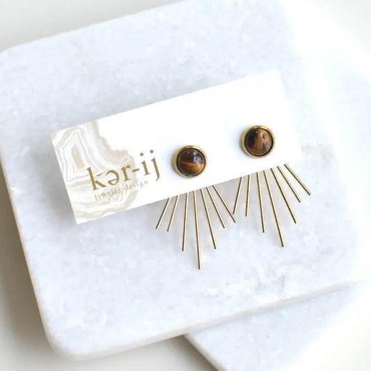 A pair of tiger eye gemstone earrings with thin gold bars spreading outward from the small studs