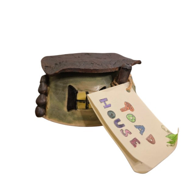 Small ceramic toad house with a window design on the side