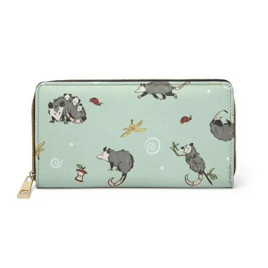 A mint green zippered wallet featuring a pattern of cartoon possums, ladybugs and banana peels