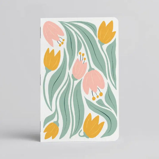 White notebook with pastel pink, yellow and green tulips on the front