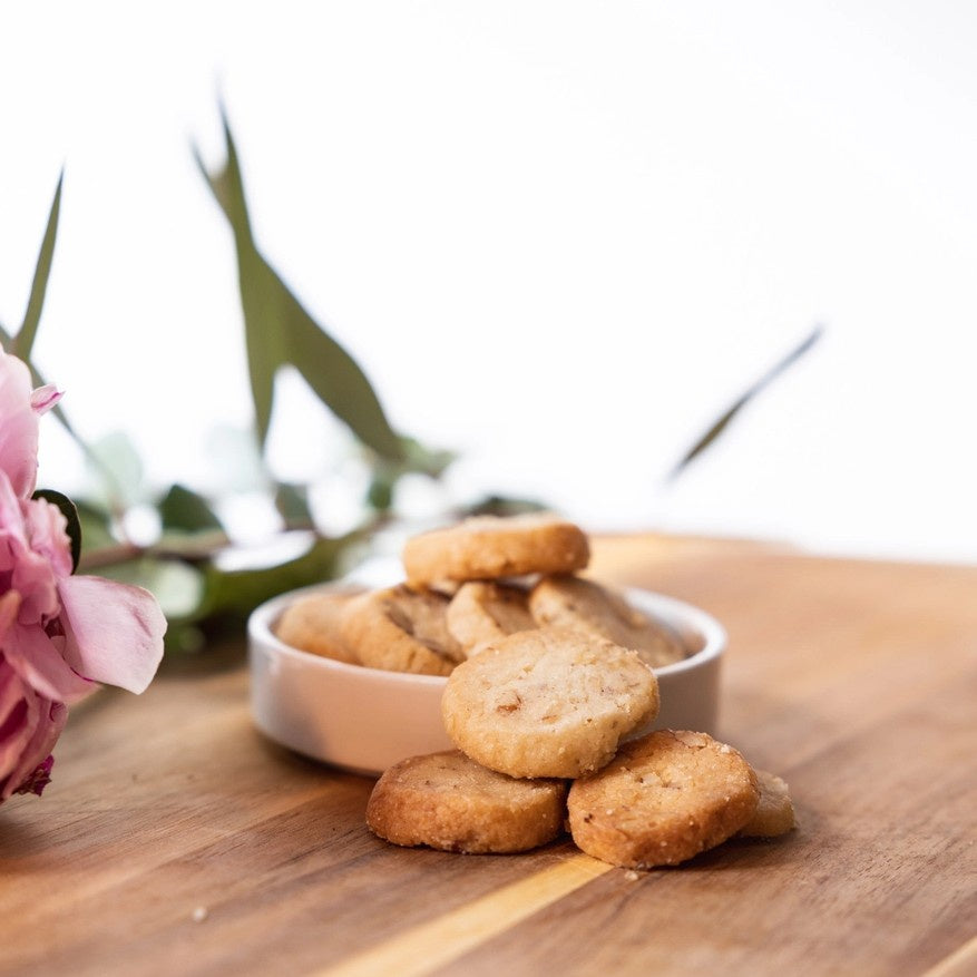 Small shortbread cookies on a wooden table