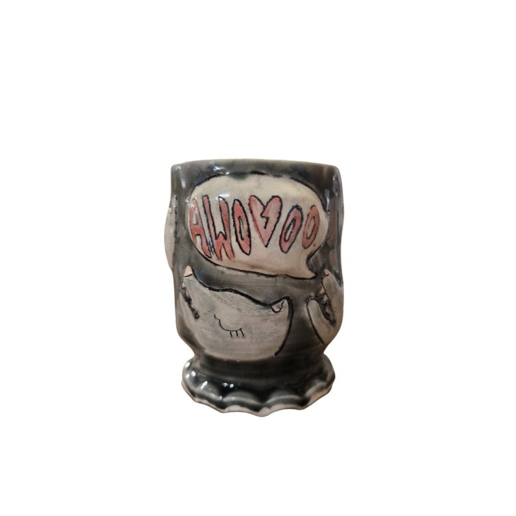 Dark gray ceramic cup with wolf heads howling "awooo" etched on the side