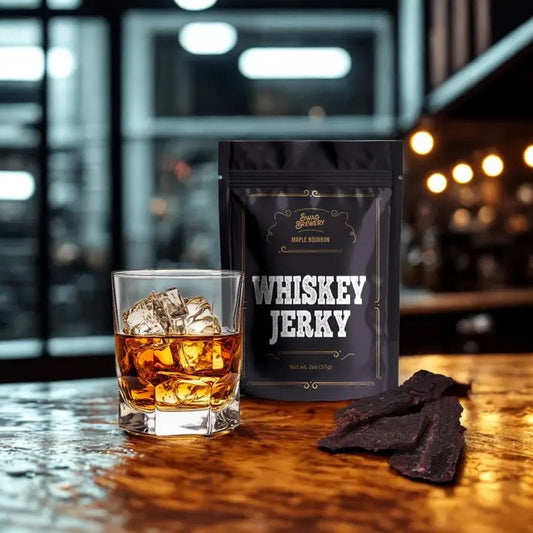 Bag of maple bourbon whiskey jerky with a glass of whisky
