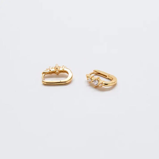 Small gold huggie earrings with white crystals