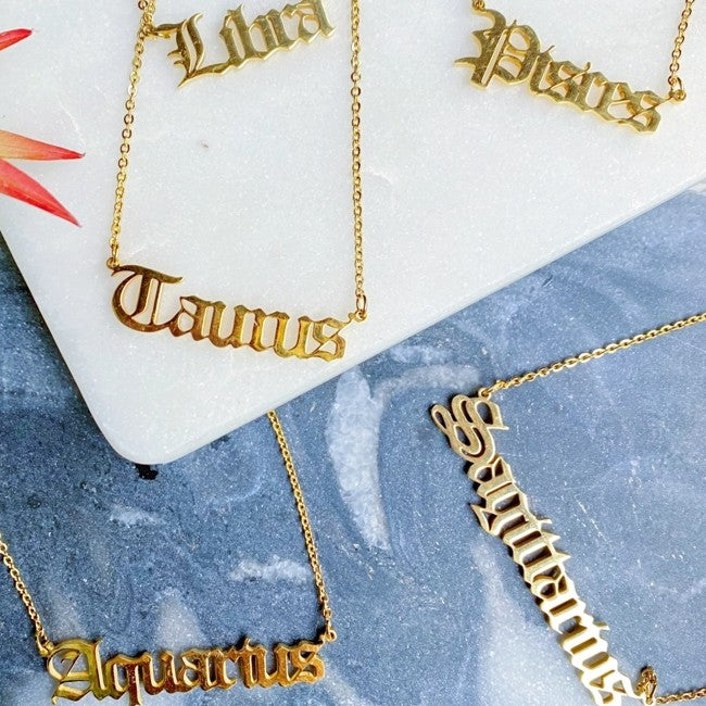 Gold necklaces with the names of Zodiac signs 