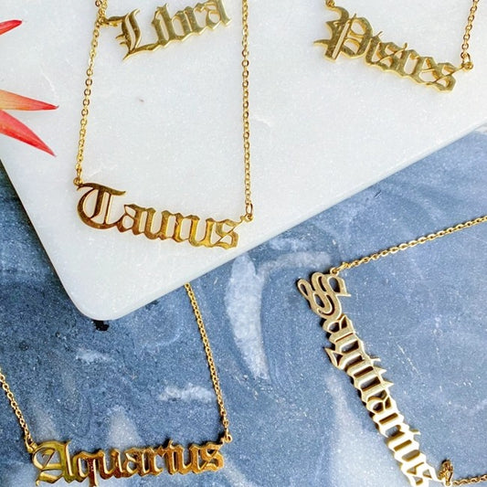 Gold necklaces with the names of Zodiac signs 