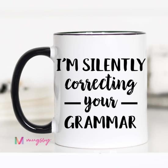 black and white correcting your grammar coffee mug