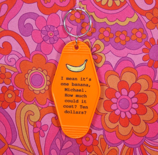 orange key chain with Lucille Bluth Quote featuring a banana above quote