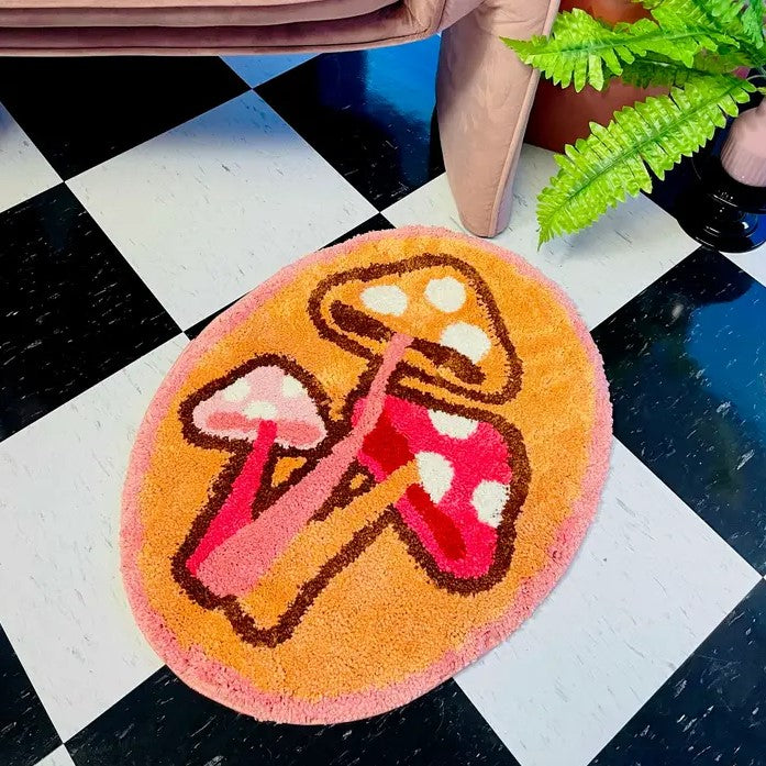 Oval Pink and Orange Rug featuring three mushrooms on a tiled floor