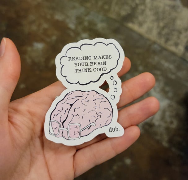 hand holding sticker of a break wearing glasses