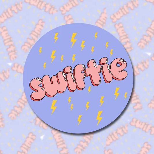 Purple Sticker with Yellow Lighting Bolts and text that says "Swiftie"